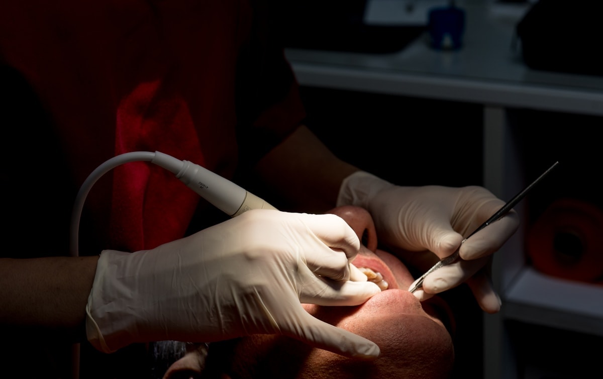 Dentist cleaning patient's teeth with tools — Preventive Care at Hooper, Too Family Dentistry