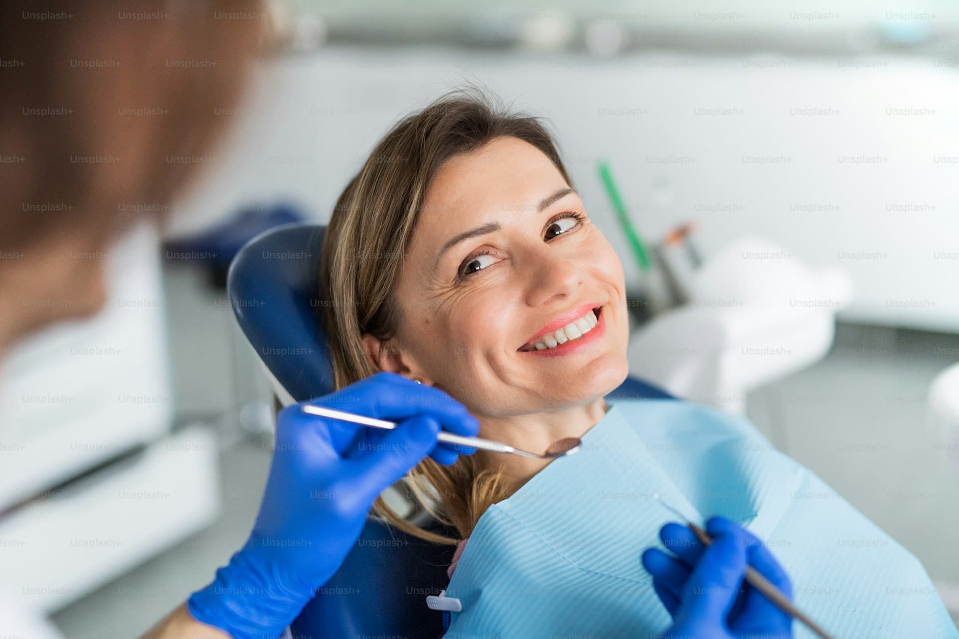 A woman has an annual dental check-up in dentist surgery