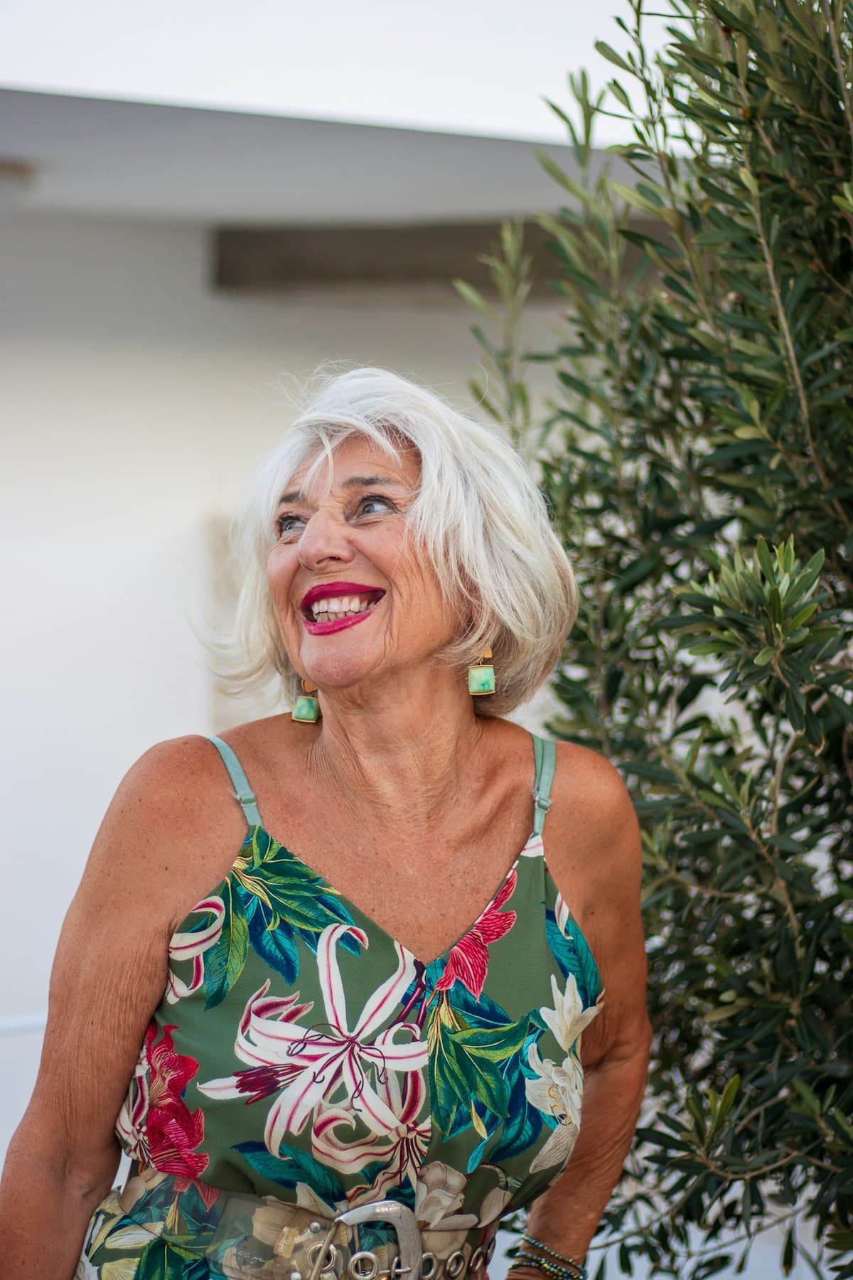 Smiling older woman with grey hair and floral dress