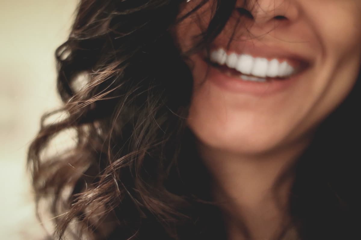 Woman with long black hair smiling close-up
