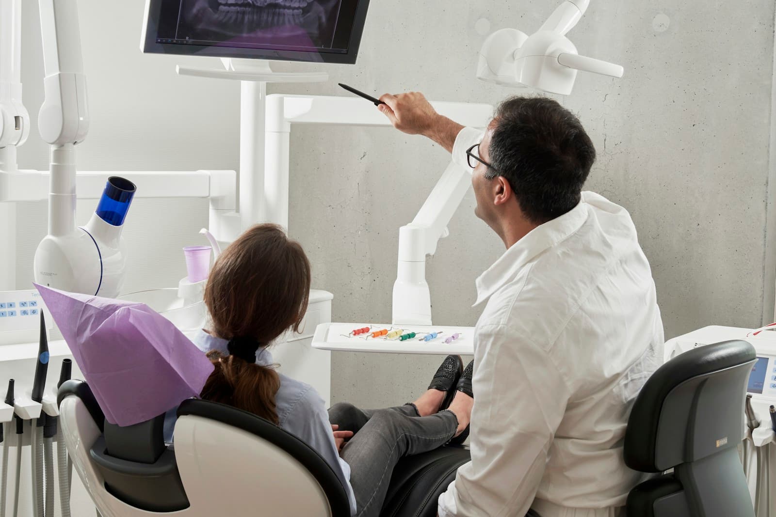 Dentist showing a panoramic dental X-ray to a patient during consultation
